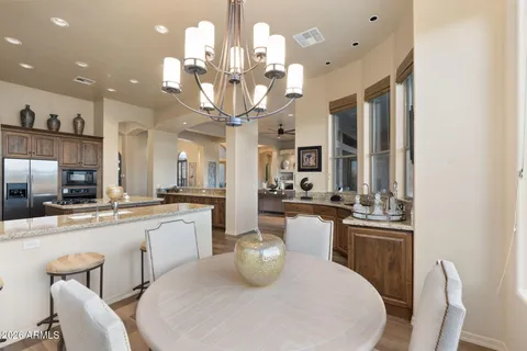 a kitchen with stainless steel appliances kitchen island granite countertop a sink stove and refrigerator