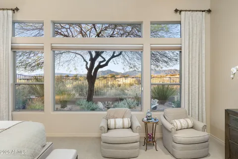 a bedroom with a large bed and a large window