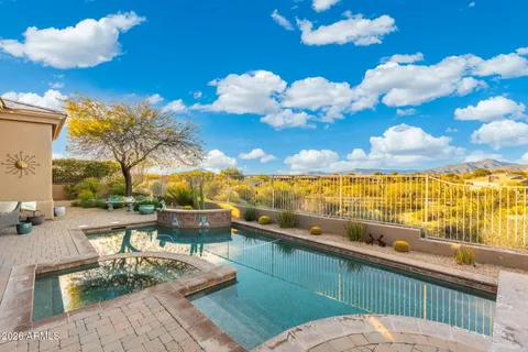 a view of a house with pool and ocean view