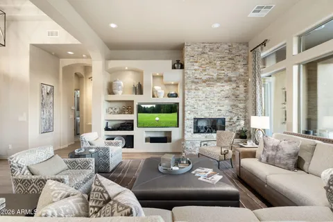 a living room with furniture a flat screen tv and a fireplace