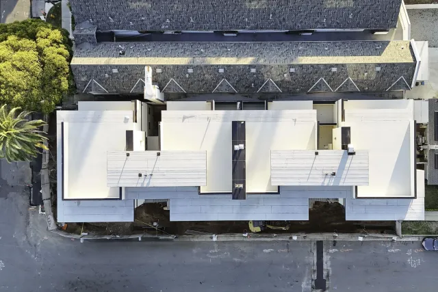 a room with gym equipment and potted plants