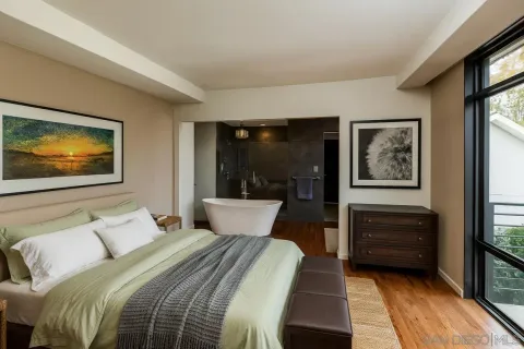 a bedroom with a bed and a flat screen tv