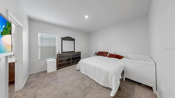 a bedroom with a bed and a tv