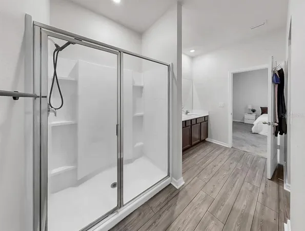 a bathroom with a glass shower door