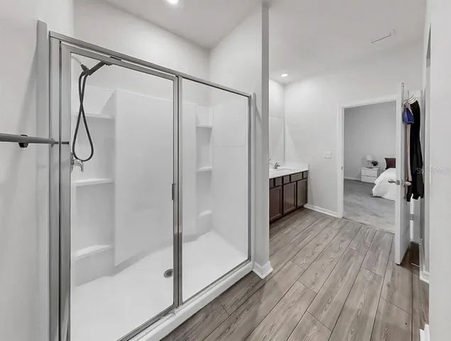 a bathroom with a glass shower door