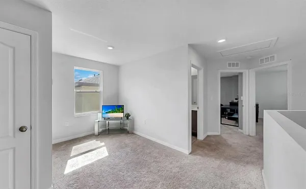 a living room with furniture and white walls