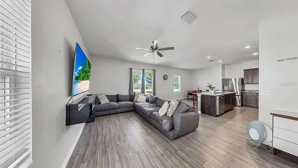 a living room with furniture and a wooden floor