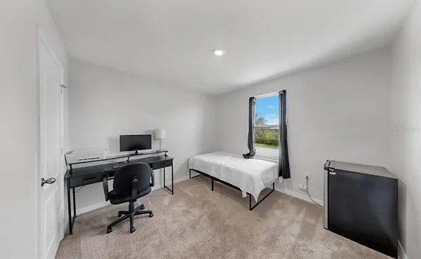 a bedroom with a workspace