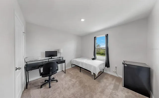 a bedroom with a workspace