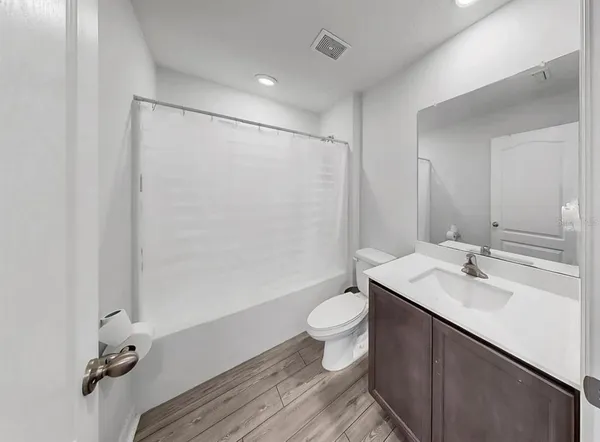 a bathroom with a sink toilet a mirror and vanity