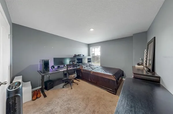 a bedroom with a workspace