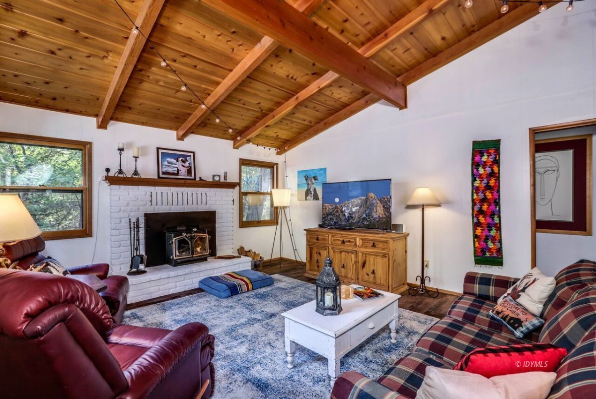 25405 Seneca Road Idyllwild, CA 92549 - Photo 11 of 61 a living room with furniture and a fireplace