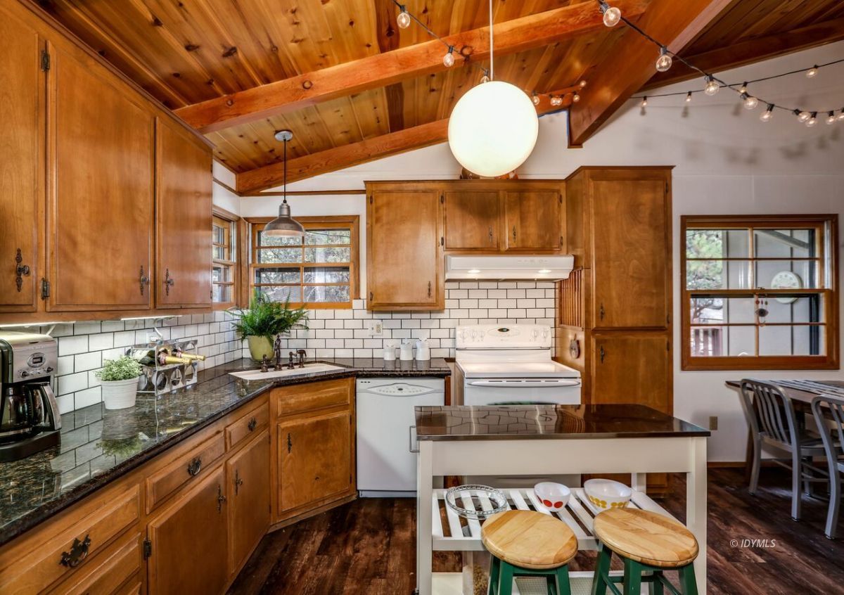 25405 Seneca Road Idyllwild, CA 92549 - Photo 16 of 61 a kitchen with stainless steel appliances granite countertop a sink and wooden cabinets
