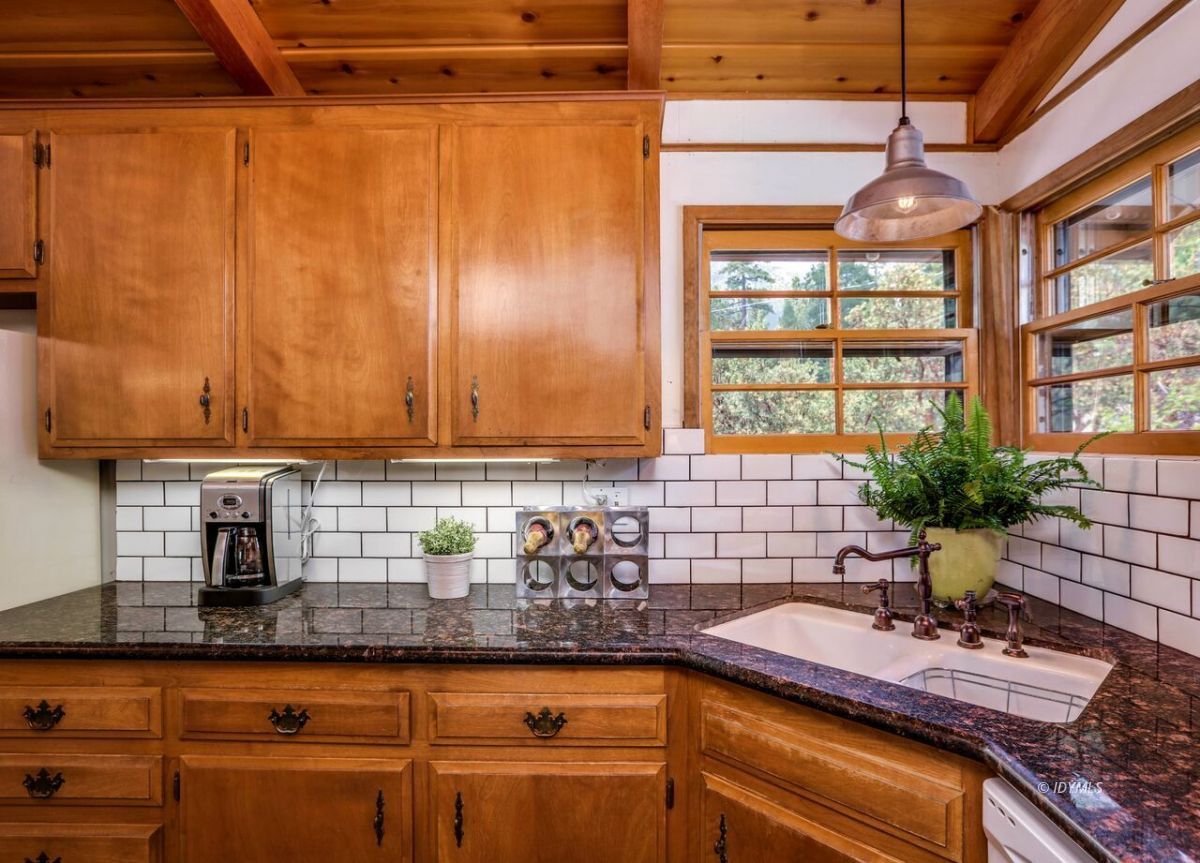 25405 Seneca Road Idyllwild, CA 92549 - Photo 18 of 61 a kitchen with a sink a counter top space and cabinets