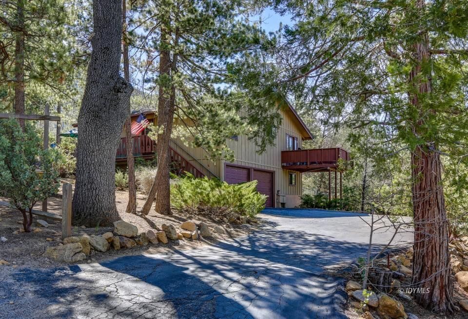 25405 Seneca Road Idyllwild, CA 92549 - Photo 2 of 61 a front view of a house with a yard and tree s