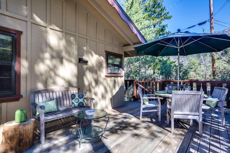 25405 Seneca Road Idyllwild, CA 92549 - Photo 43 of 61 a roof deck with table and chairs under an umbrella