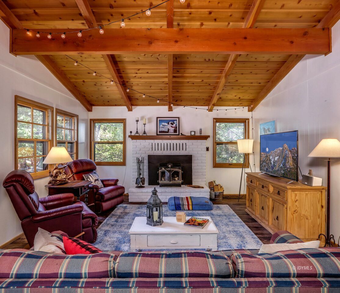 25405 Seneca Road Idyllwild, CA 92549 - Photo 9 of 61 a living room with furniture a fireplace and a flat screen tv