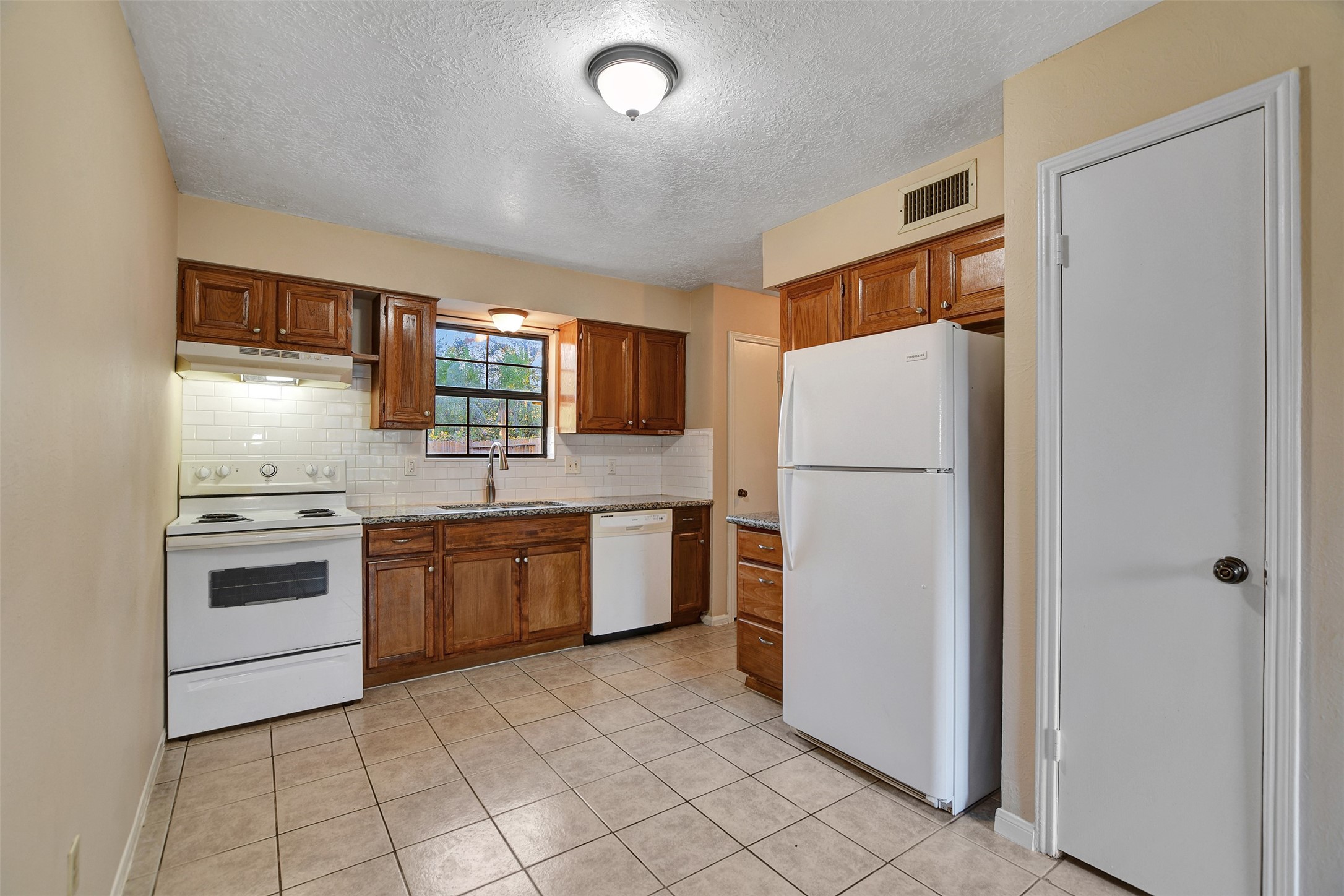 1706 Longview Street, Unit 1 Conroe, TX 77301 - Photo 12 of 32 a kitchen with a refrigerator sink and stove