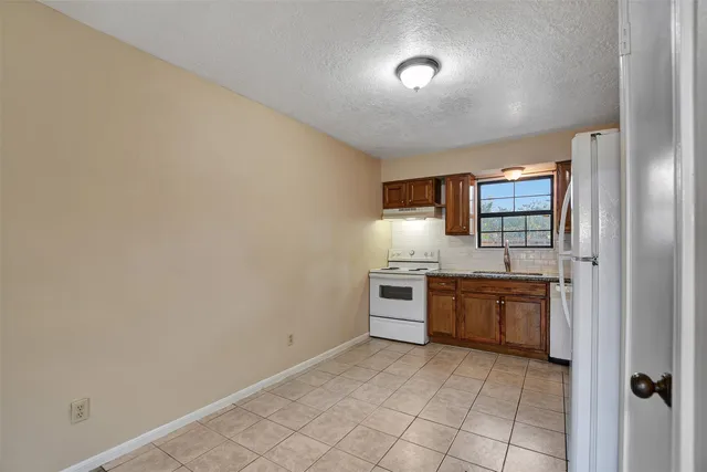 a large kitchen with cabinets and stainless steel appliances