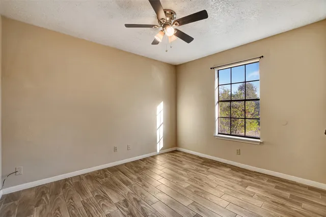 wooden floor in an empty room with a window