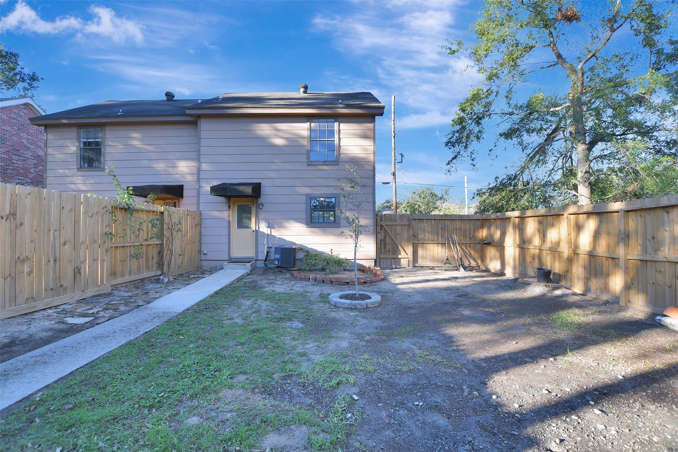 1706 Longview Street, Unit 1 Conroe, TX 77301 - Photo 30 of 32 a view of a house with a yard
