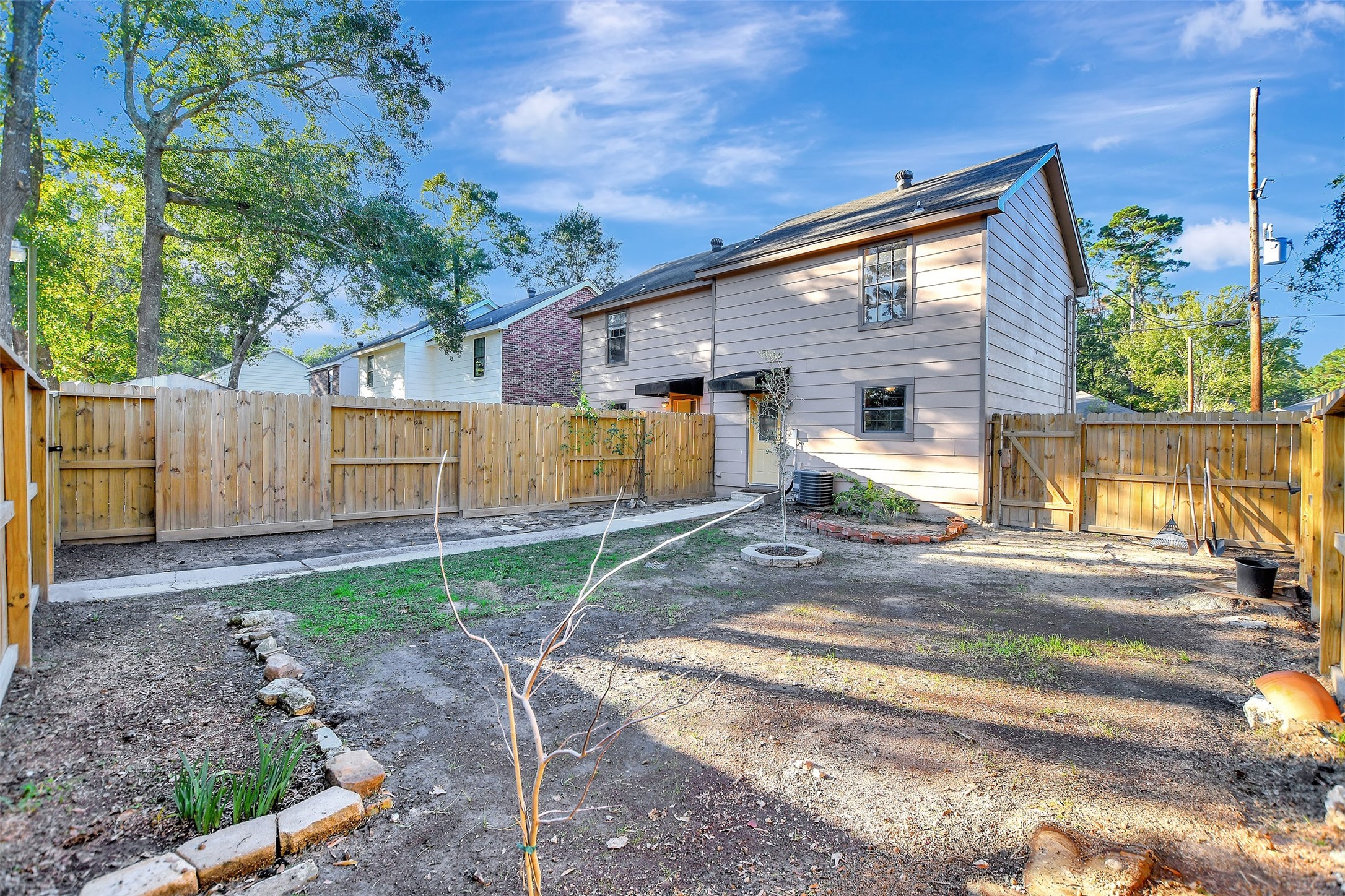 1706 Longview Street, Unit 1 Conroe, TX 77301 - Photo 31 of 32 a view of a house with a backyard