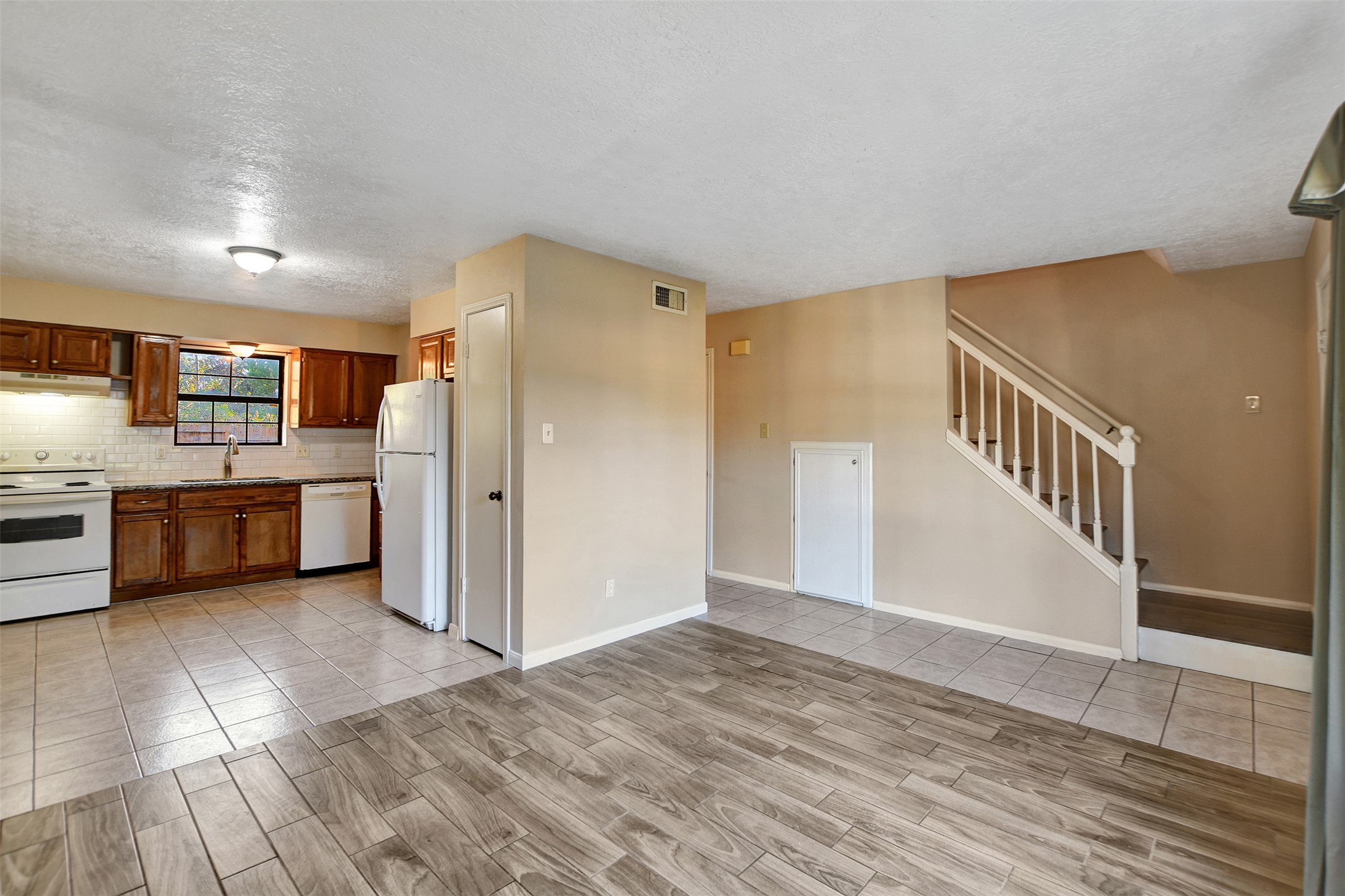 1706 Longview Street, Unit 1 Conroe, TX 77301 - Photo 8 of 32 a view of a kitchen with a sink cabinets and a living room
