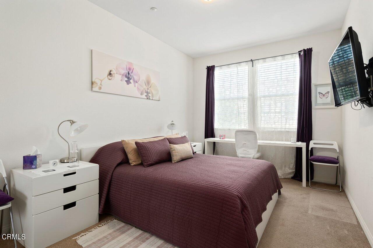 719 Forest Park Boulevard Oxnard, CA 93036 - Photo 18 of 39 a bedroom with a bed and a flat tv screen on the dresser