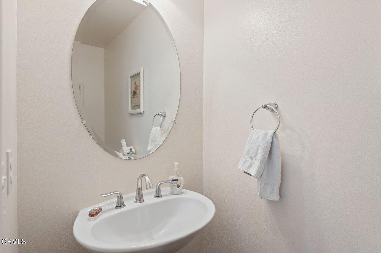 719 Forest Park Boulevard Oxnard, CA 93036 - Photo 23 of 39 a bathroom with a sink and mirror