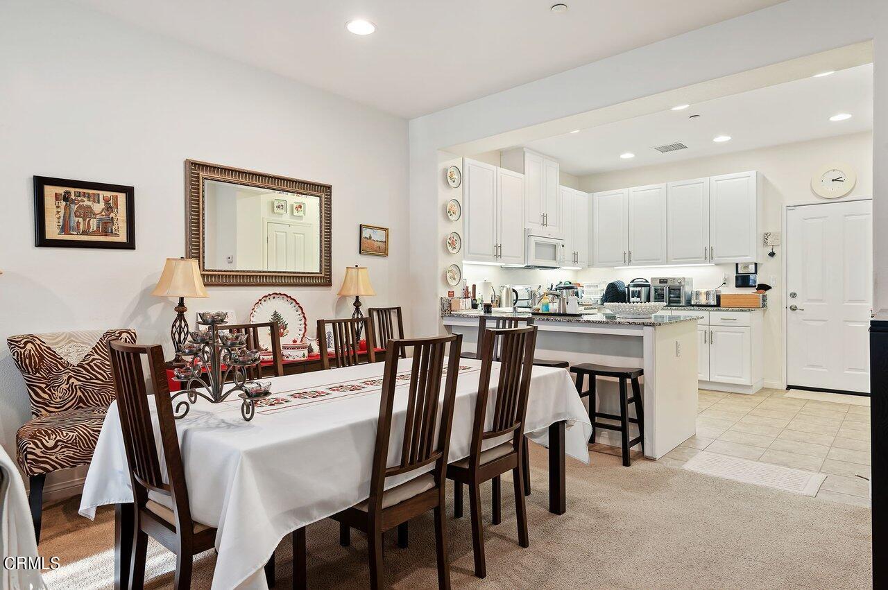 719 Forest Park Boulevard Oxnard, CA 93036 - Photo 10 of 39 a kitchen with a dining table chairs and refrigerator