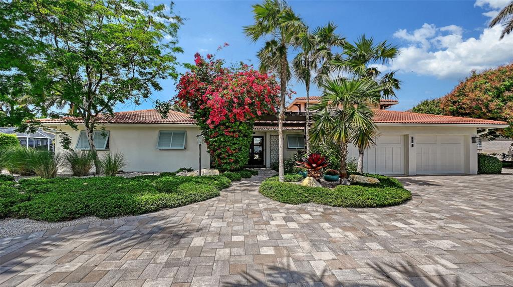 531 Wedge Lane Longboat Key, FL 34228 - Photo 1 of 28 a front view of a house with a yard and a garage