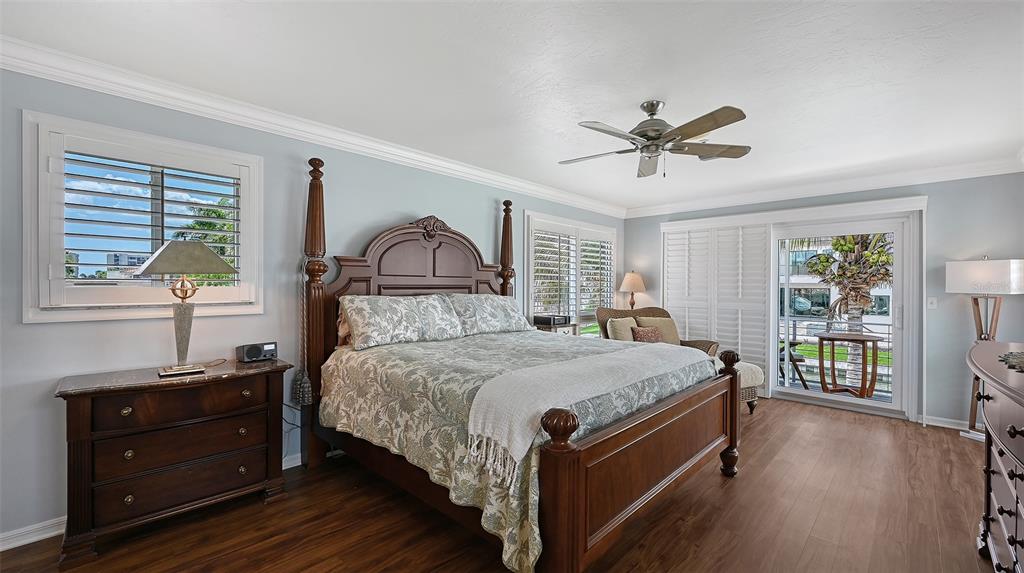 531 Wedge Lane Longboat Key, FL 34228 - Photo 11 of 28 a bedroom with a bed and a dresser with wooden floor