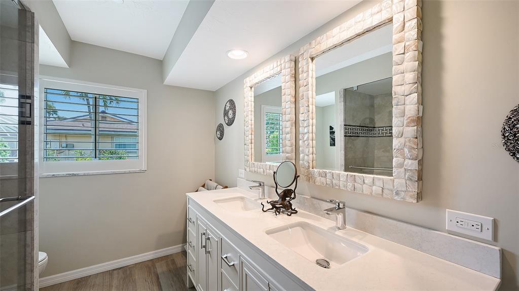 531 Wedge Lane Longboat Key, FL 34228 - Photo 16 of 28 a bathroom with a sink vanity granite tub and a mirror