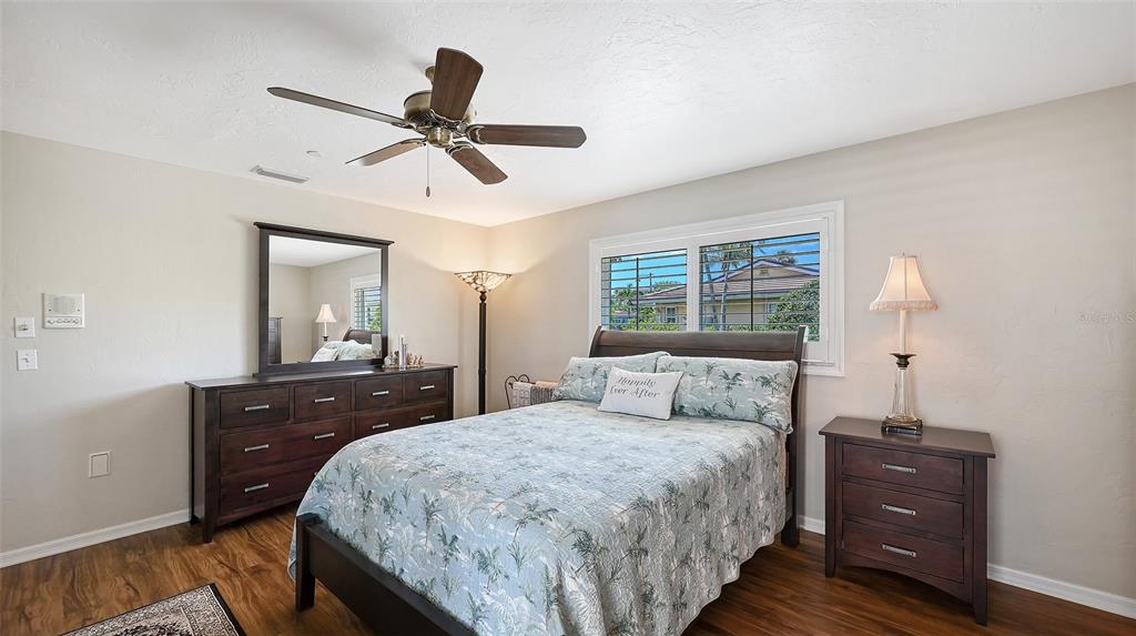 531 Wedge Lane Longboat Key, FL 34228 - Photo 17 of 28 a bedroom with a bed and a dresser