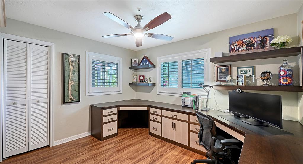 531 Wedge Lane Longboat Key, FL 34228 - Photo 19 of 28 a kitchen with stainless steel appliances sink stove and wooden floor