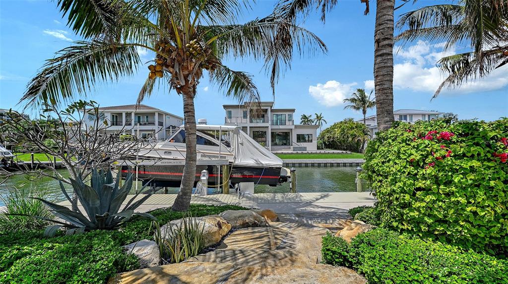 531 Wedge Lane Longboat Key, FL 34228 - Photo 2 of 28 a front view of multiple houses with yard
