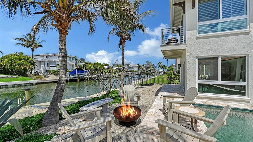531 Wedge Lane Longboat Key, FL 34228 - Photo 23 of 28 a swimming pool with outdoor seating and yard
