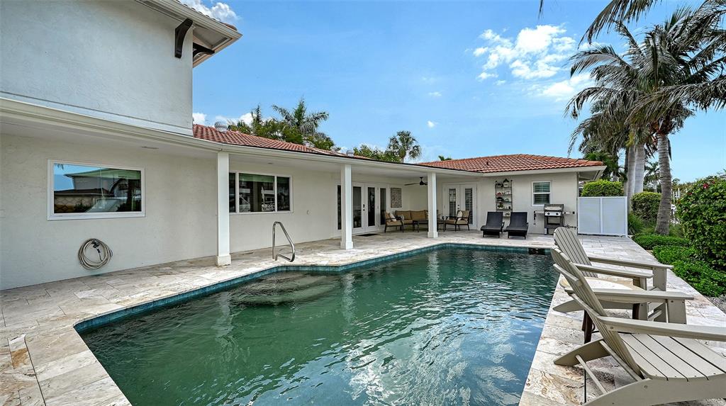 531 Wedge Lane Longboat Key, FL 34228 - Photo 26 of 28 a view of a house with swimming pool and sitting area