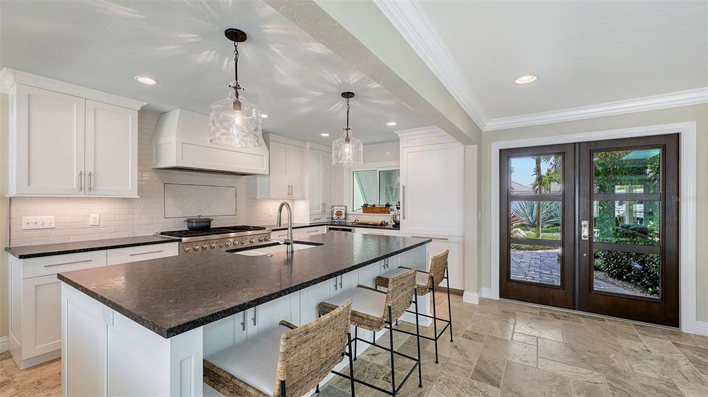 531 Wedge Lane Longboat Key, FL 34228 - Photo 4 of 28 a kitchen with kitchen island a large counter top space appliances and cabinets