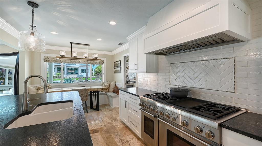 531 Wedge Lane Longboat Key, FL 34228 - Photo 5 of 28 a kitchen with granite countertop a stove and a sink