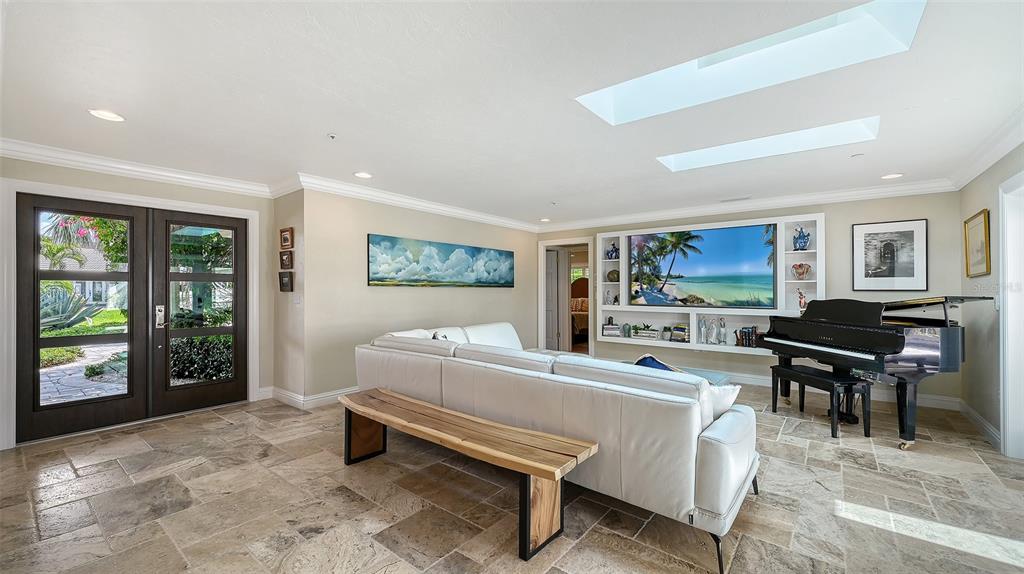 531 Wedge Lane Longboat Key, FL 34228 - Photo 7 of 28 a living room with furniture a large window and a flat screen tv