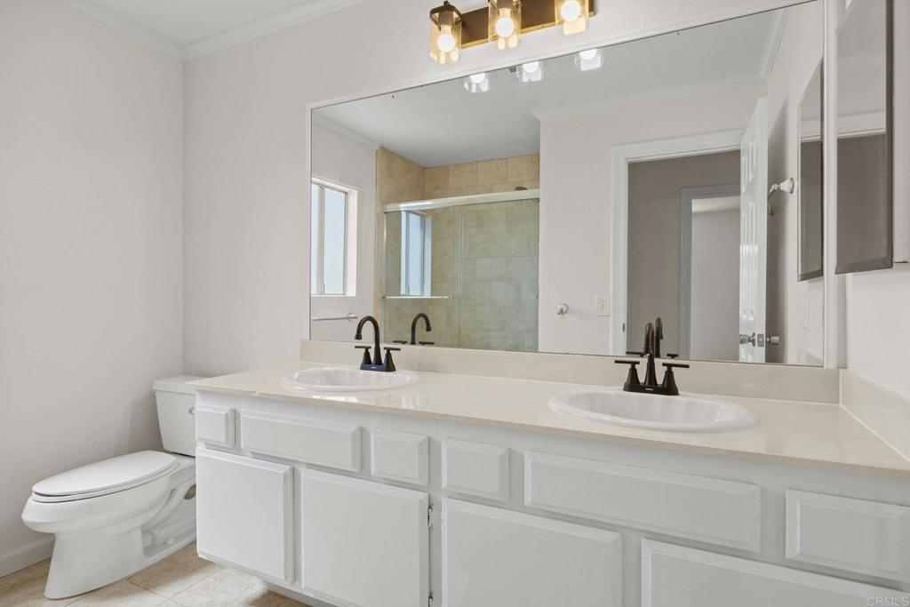 4595 Blackwell Road Oceanside, CA 92056 - Photo 34 of 47 a bathroom with a sink and a toilet