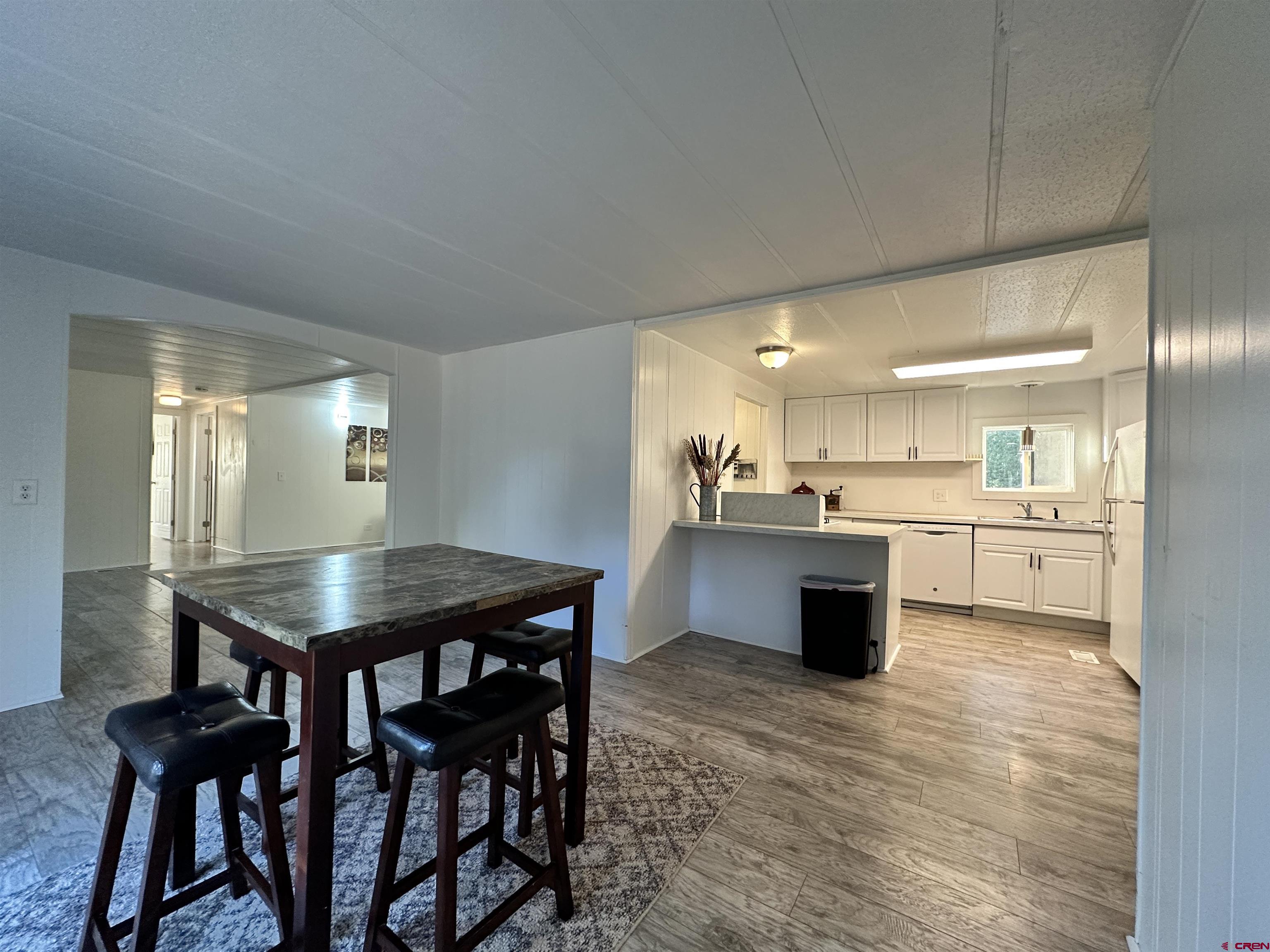 468 Rio Grande Road South Fork, CO 81154 - Photo 12 of 43 a kitchen with a table and chairs in it