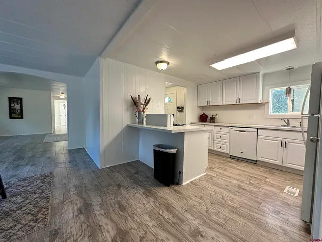 a kitchen with a sink cabinets and window