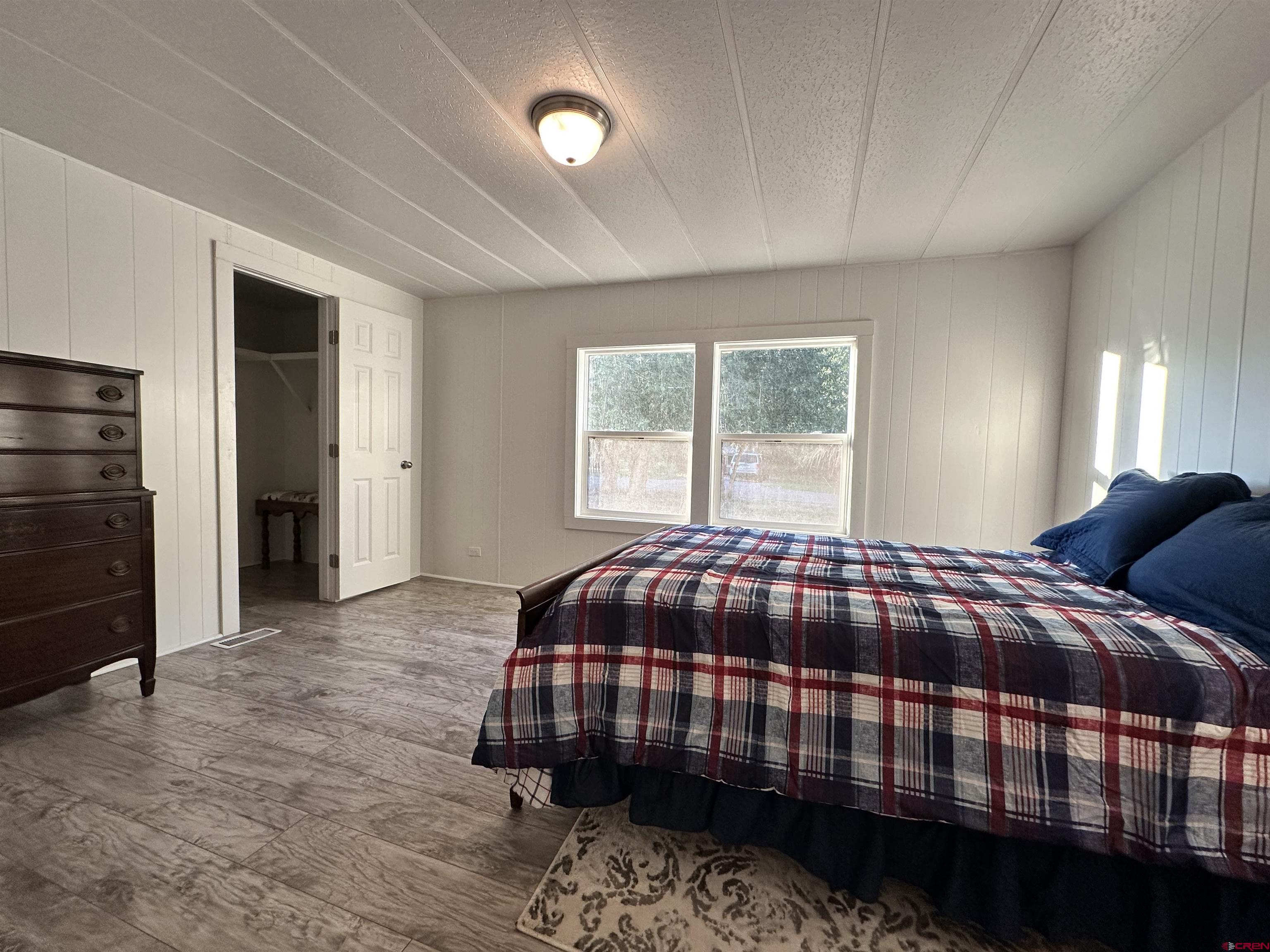 468 Rio Grande Road South Fork, CO 81154 - Photo 21 of 43 a bedroom with a bed and a window
