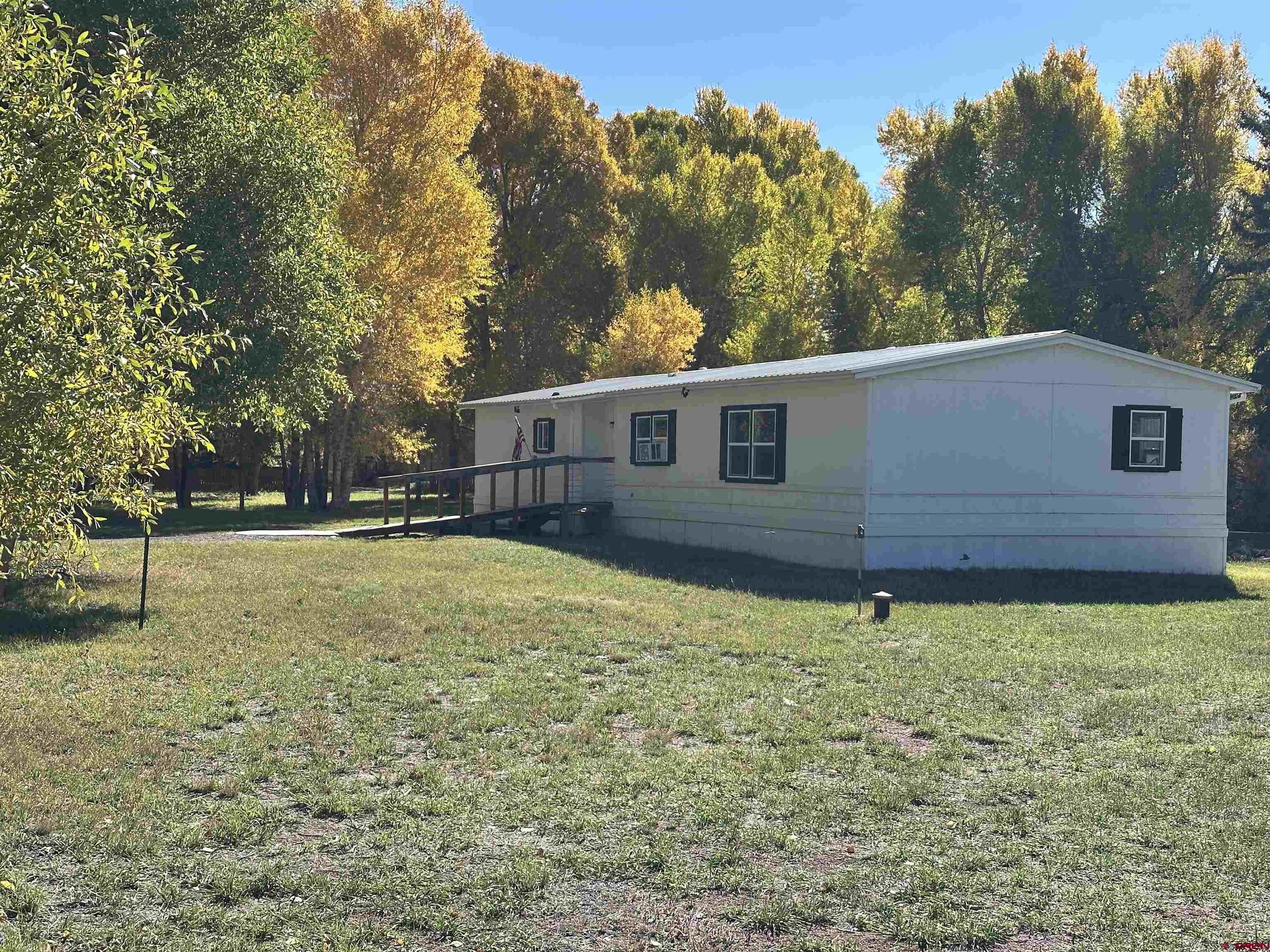 468 Rio Grande Road South Fork, CO 81154 - Photo 27 of 43 a view of a house with a yard
