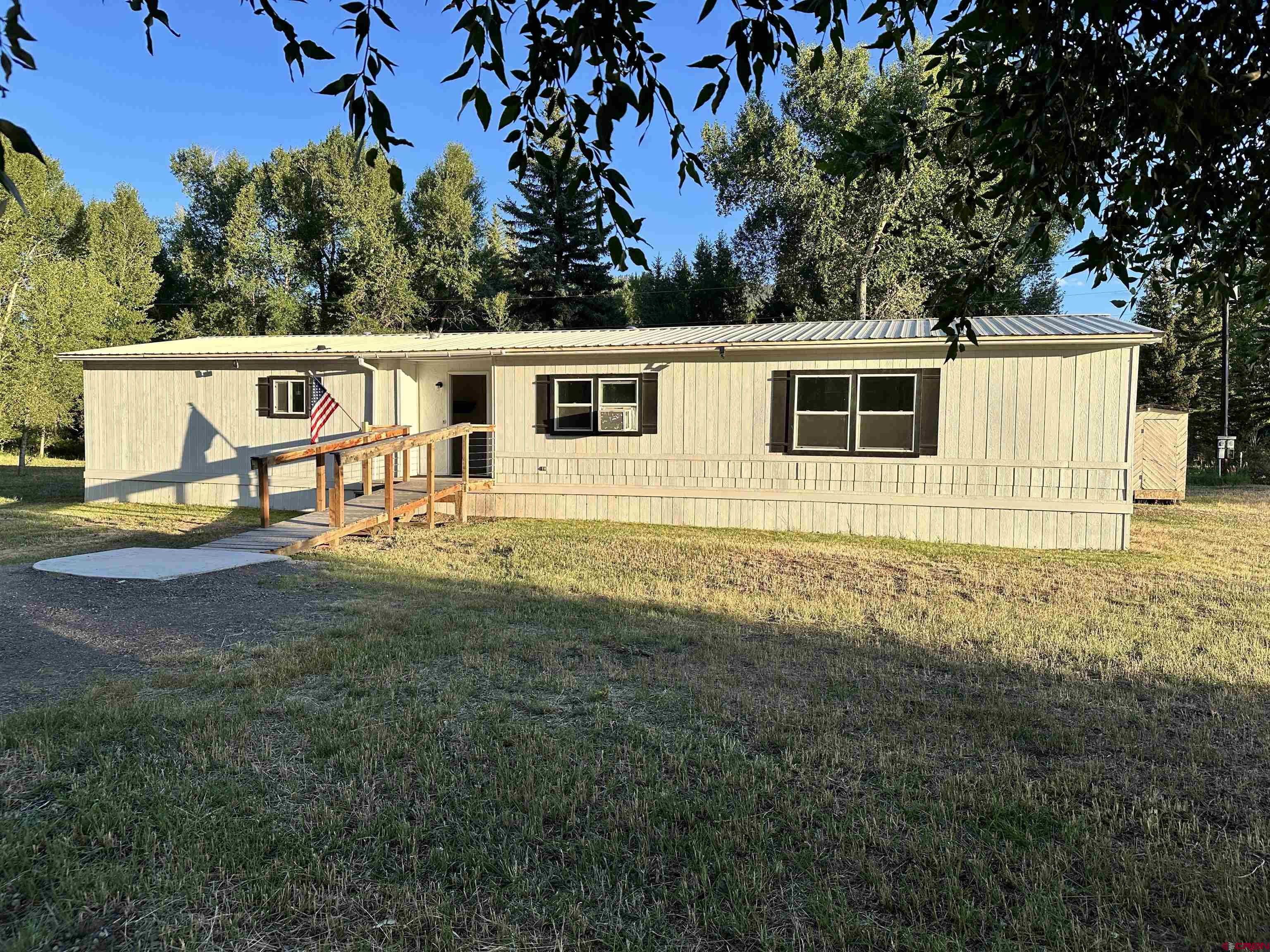 468 Rio Grande Road South Fork, CO 81154 - Photo 35 of 43 a view of a backyard with plants and large tree