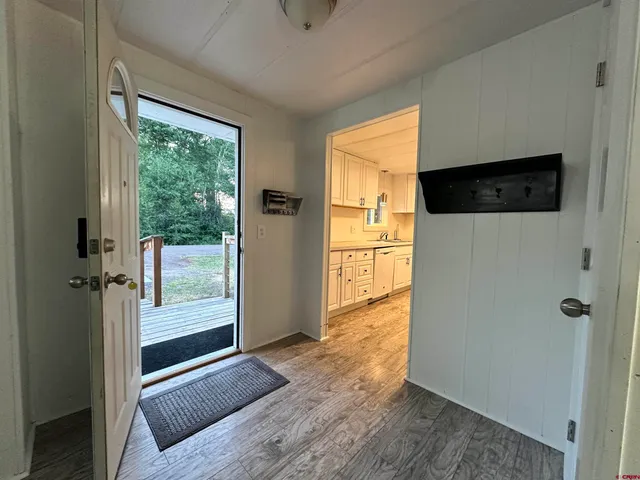 a view of entryway with wooden floor and door