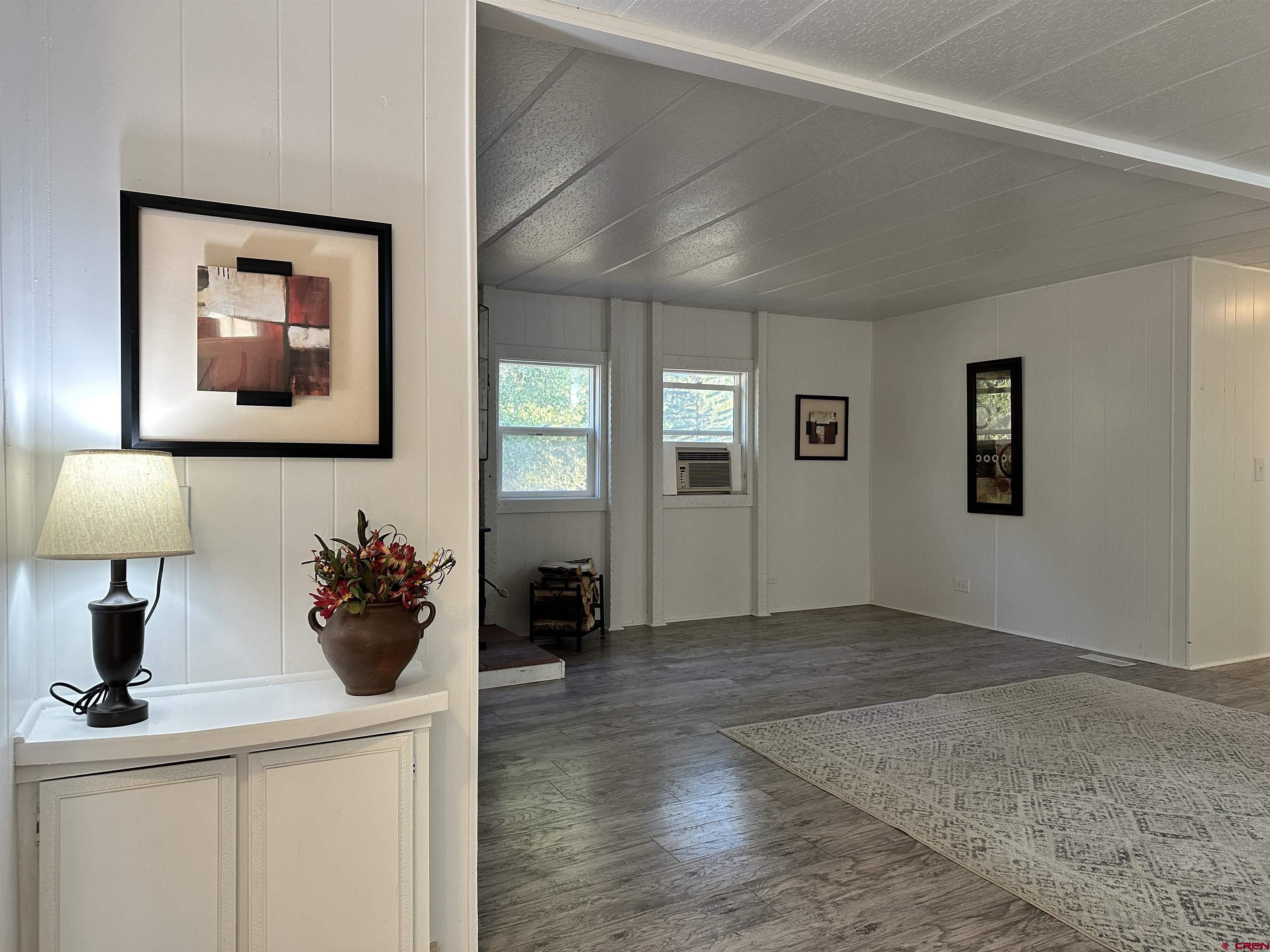 468 Rio Grande Road South Fork, CO 81154 - Photo 7 of 43 a view of a hallway with a flower pot and a flat screen tv