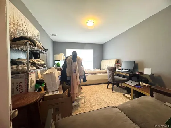 a bedroom with furniture and a window